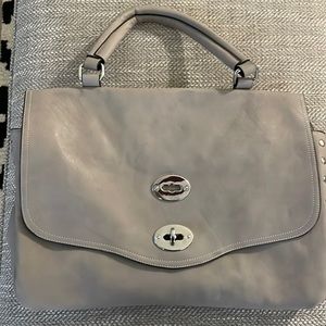 Purse Bag with snap closure.  Inner lining with divider. 2 zipper pockets.